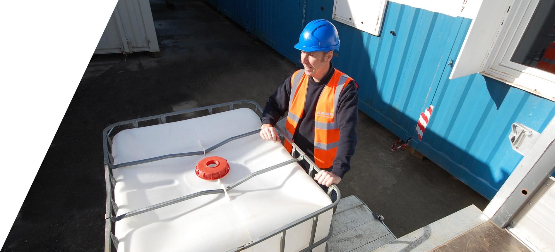 operative at welfare unit standing at water bowser